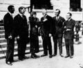 Dr. Hugo Eckener, in Washington, became a member of the Red Cross when enrolled by Miss Elizabeth Potter. Others in the group are Capt. George W. Steele, new commander of the ZR-3; Secretary of the Navy Wilbur, Dr. Emil L. Baer, secretary of the German embassy, and Capt. Lehman. Dr. Eckener commanded the ZR-3 on its trip from Germany to the United States.
